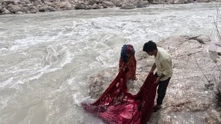 Nomads washing blankets in the roaring river [upl. by Toor]