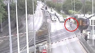 Man narrowly missed by train after jumping over crossing barriers [upl. by Rednav]