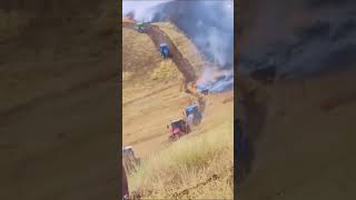 FARMERS PUTTING IN A FIRE BREAK TO STOP GRASS FIRE WITH TRACTORS [upl. by Names]