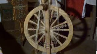 Spinning is in Ukrainian Hut on the Spindle Wound Yarn Wooden Spinning Wheel in the Ukrainian Hut [upl. by Dnalyar]