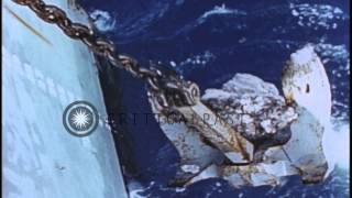 Anchor being pulled up a ship underway in the Pacific Ocean during World War II HD Stock Footage [upl. by Ueihtam]