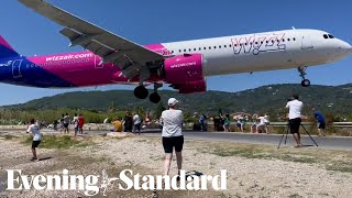 Terrifying moment a Wizz Air plane flies just metres above tourists’ heads at Greek airport [upl. by Vilhelmina]