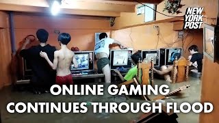 Online gaming addicts in cafe continue playing through typhoon flood  New York Post [upl. by Raamal53]