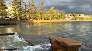 Early morning at Terrigal Dark storm clouds Bright sunlight Kayakers and paddlers [upl. by Ahsekyw234]