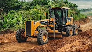 Road construction work in a rural area with a motor grader and bulldozer leveling land on the road [upl. by Xerxes]