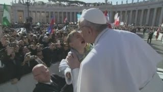 Pope Francis kisses baby and disabled man at inaugural mass [upl. by Asiralc]