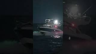 Blue yacht passing the Haulover Inlet Jetty after dark [upl. by Oilasor]