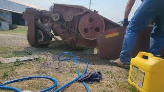 Lubricating and inspecting a Hesston 1120 mower Haybine Hay season begins [upl. by Enirahtac]