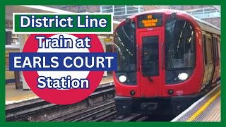 Train on the District line at Earls Court station [upl. by Uaeb355]