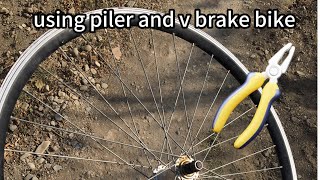 how to true a wheel without truing stand and special tools with just using v brake bike and piller [upl. by Ahsiret]