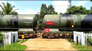 An Oil Tanker Train Passing Through A Rural Railroad Level Crossing [upl. by Enelrak]