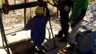 Entering a small scale mine shaft for antimony ore stibnite with a winch hoist in Zimbabwe [upl. by Naruq762]