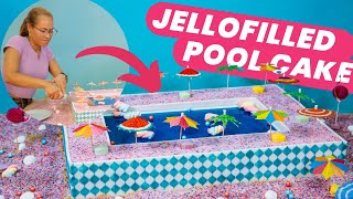 Jellofilled SWIMMING POOL CAKE with marshmallow floaties 🍰🤣  How to Cake It With Yolanda Gampp [upl. by Allesiram]