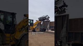 Crushed cars get loaded into a semi on their way to the car shredder [upl. by Suivatnod]