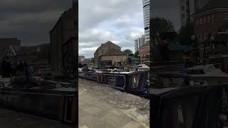 The view at Granary Wharf in Leeds moored narrowboats and old warehouse wharf buildings waterways [upl. by Caresa]