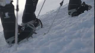 Tourist people in crampons walking on snow trail in mountain close up [upl. by Darb]