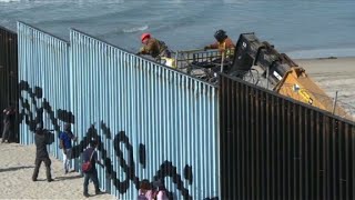 US reinforces border wall in Tijuana as migrants look on [upl. by Roby633]