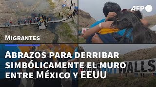 Migrantes se abrazan y derriban simbólicamente el muro entre México y EEUU  AFP [upl. by Hepsoj]