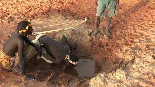 Hadzabe bushmen drinking water from river bed [upl. by Htevi148]