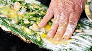 Grandmother cooking by hand in a cauldronSeafood green onion pancake cabbage pancake [upl. by Samp]