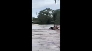 Terrifying moment two men swallowed by floodwaters in Queensland [upl. by Bonina973]