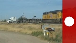 Dramatic footage Train hits trailer truck stuck on tracks Holy smokes says witness [upl. by Vinnie]