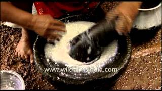 Traditional process of rice grinding with a stone [upl. by Avram]