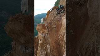 Excavators cut through the mountains to build roads [upl. by Aieken]