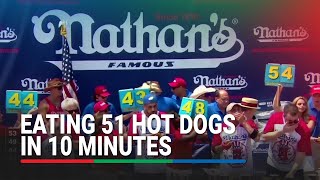 Hot dog eating champions chomp their way to victory in July 4 competition  ABS CBN News [upl. by Kalmick]