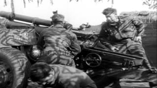 US 899th Field Artillery Battalion 75th Division troops load 105mm howitzers andHD Stock Footage [upl. by Adialeda]