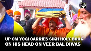 UP CM Yogi Adityanath carries Sikh Holy Book on his head on ‘Veer Bal Diwas’ in Lucknow [upl. by Trebloc782]