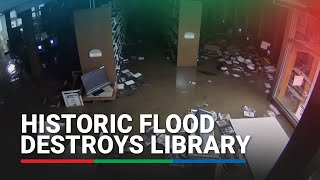 Flood breaks through library wall in NY destroys thousands of books [upl. by Nirol533]