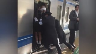 Professional Pushers Shove Passengers Onto Busy Tokyo Train [upl. by Rurik614]