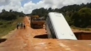 Bus washed away by floodwater after collapsing in sinkhole [upl. by Ecirual]