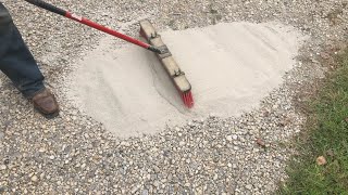 brushing CHEAP concrete onto a gravel driveway adding strength and resilience [upl. by Ailic]