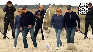 Biden stumbles multiple times needs assist from Jill as he struggles to walk on Delaware beach [upl. by Robina]