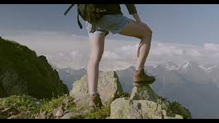 A person standing on rocks atop a mountain [upl. by Vano]