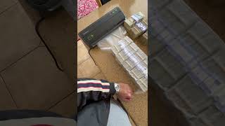 Person is vacuum sealing a large amount of money [upl. by Carlita]