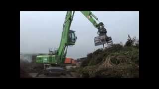 SENNEBOGEN  Recycling Material Handler 825 feeding shredder loading compost [upl. by Drehcir]