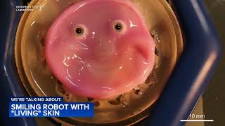 Smiling robot has a face covered in living skin [upl. by Shiller]