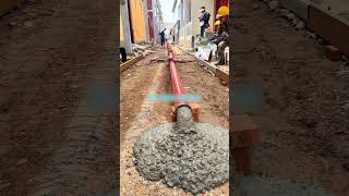 The process of pouring concrete from red metal pipe [upl. by Ilime]