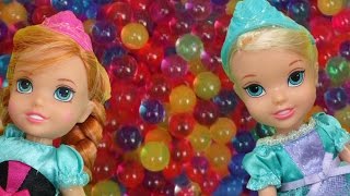 Elsa and Anna toddlers have fun in ORBEEZ  They slide into colorful water beads [upl. by Yroc619]