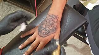 Tiger face tattoo on hand [upl. by Kevina]