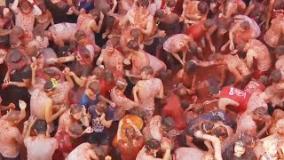 Food Fight 20000 People Toss Tomatoes at Spains La Tomatina [upl. by Bulley923]