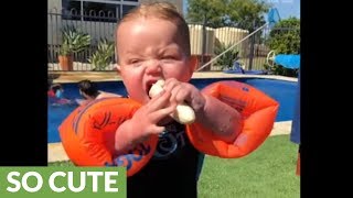 Baby attempts to eat banana while wearing floaties [upl. by Diarmuid]