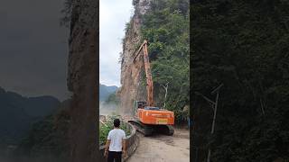 Long arm excavator clears dangerous rocks on highway cliffs [upl. by Aicitel]