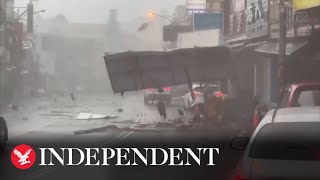 Debris blown down road as Typhoon Koinu brings violent winds to Taiwan [upl. by Ahsiret]