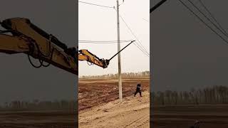 Wire laying process from ground onto a pole with an excavator [upl. by Nibla]