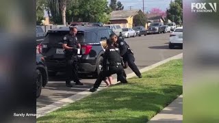 Police officers stop fellow officer punching handcuffed woman during arrest [upl. by Nataline632]