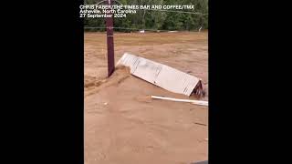 Shipping container being swept away in powerful flooding in Asheville [upl. by Ydnih]